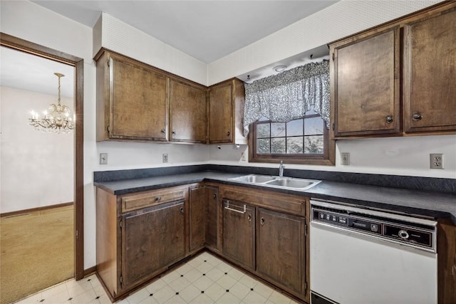 kitchen featuring a sink, dark countertops, light floors, and dishwasher