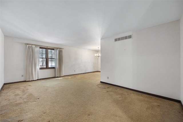 unfurnished room featuring baseboards, carpet flooring, visible vents, and an inviting chandelier