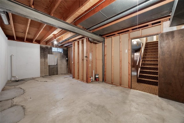 basement with brick wall and stairs