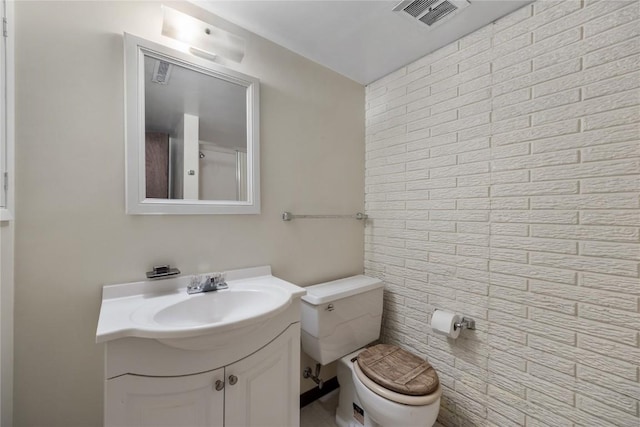 bathroom with visible vents, vanity, and toilet