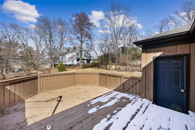 snow covered deck with fence