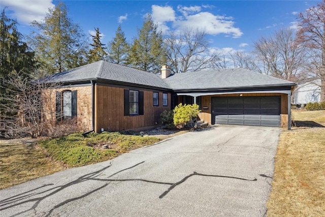 single story home with roof with shingles, driveway, a chimney, and an attached garage