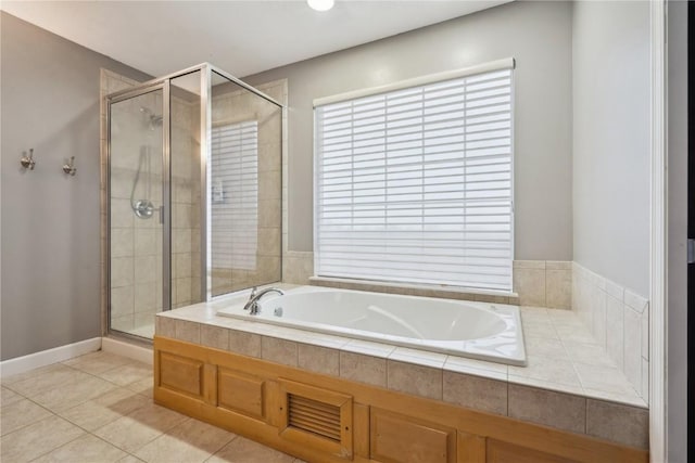 full bath featuring a stall shower, tile patterned flooring, and a bath