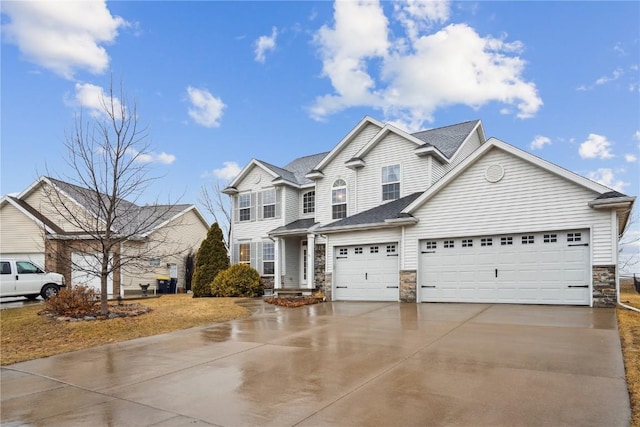 view of front of home with an attached garage, stone siding, and concrete driveway