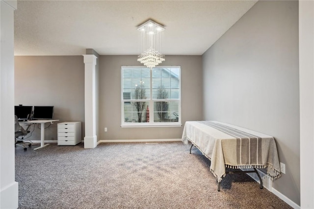 bedroom featuring an inviting chandelier, carpet flooring, decorative columns, and baseboards