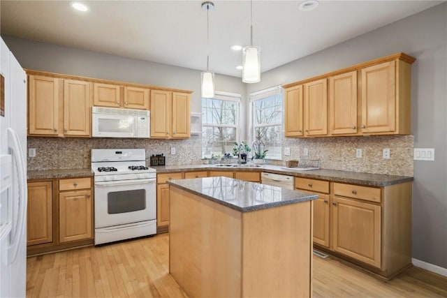 kitchen featuring light wood-type flooring, white appliances, and light brown cabinets