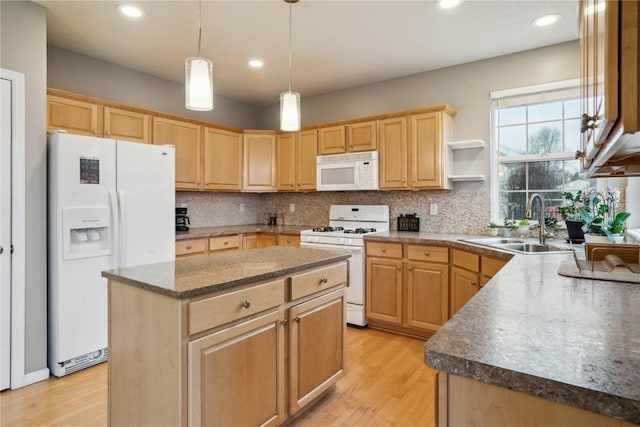 kitchen featuring white appliances, backsplash, light wood-type flooring, and a sink