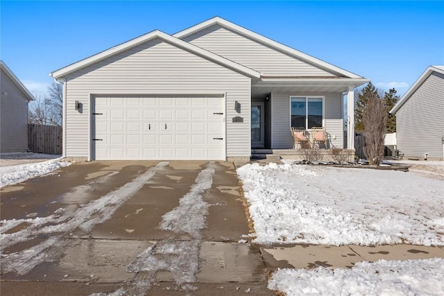 view of front facade with a porch, driveway, an attached garage, and fence