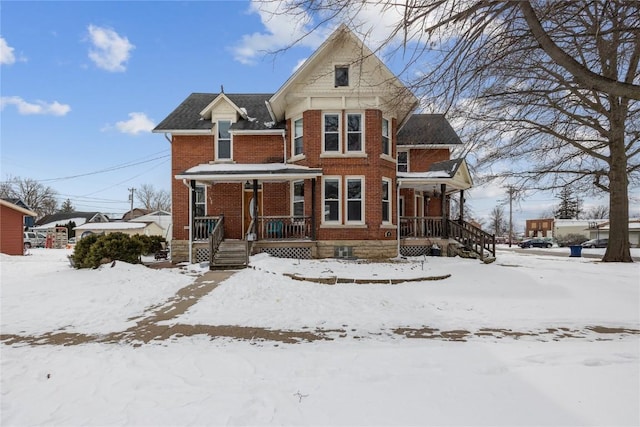 view of front of house featuring covered porch and brick siding