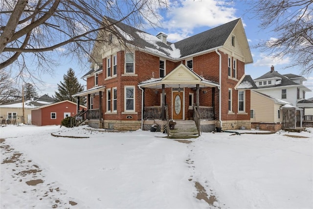 view of front facade with brick siding and a porch