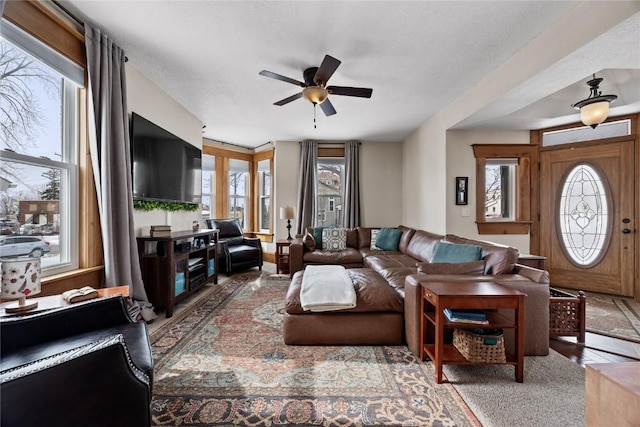 living area featuring a ceiling fan