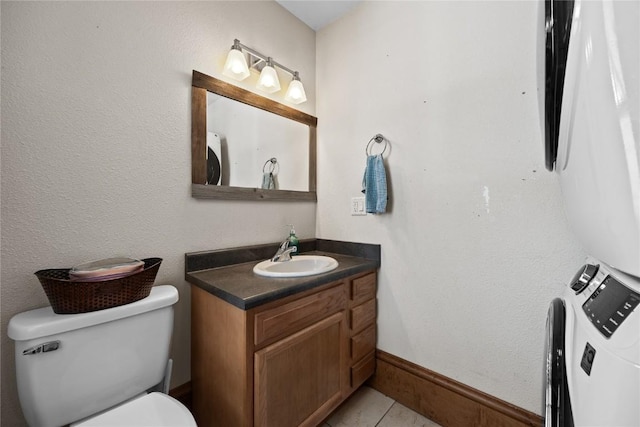 half bath with toilet, tile patterned floors, and vanity