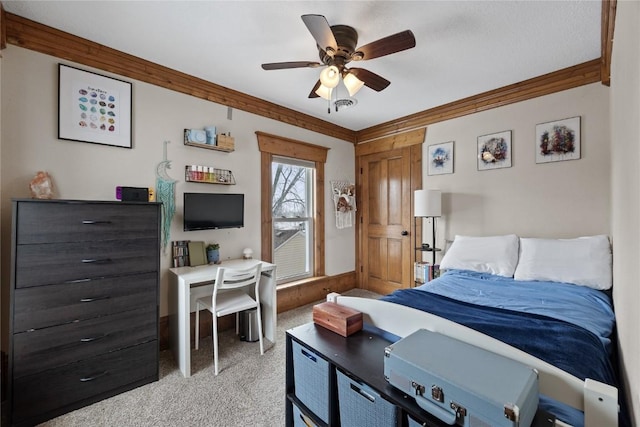 bedroom with ornamental molding, a ceiling fan, and light colored carpet