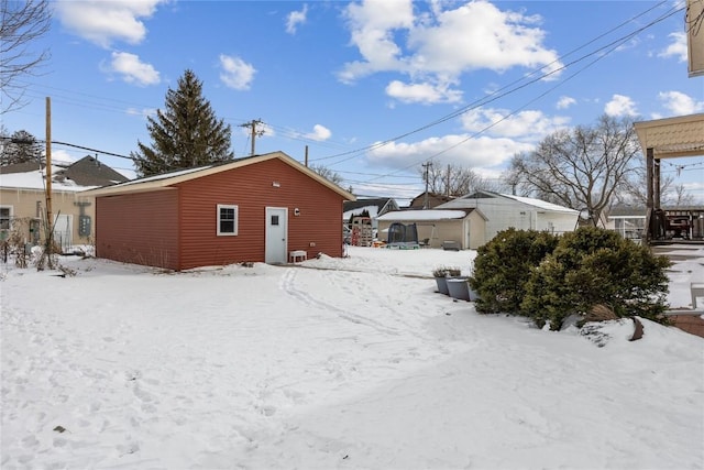 snow covered house with a garage