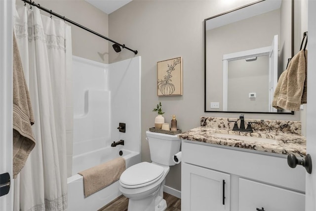 full bath with toilet, shower / bath combo, wood finished floors, and vanity