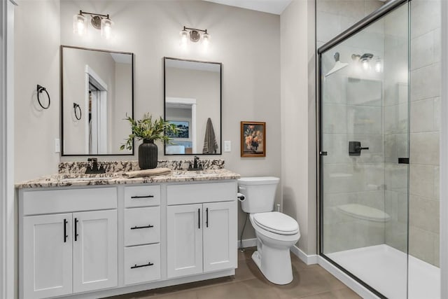 full bathroom with a stall shower, a sink, toilet, and double vanity