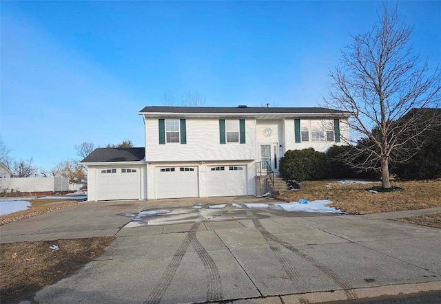 bi-level home featuring driveway and an attached garage