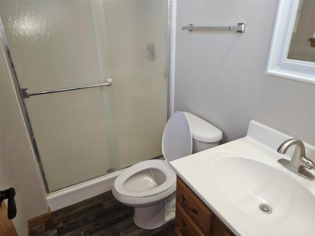 203 Maxwell Dr, Shellsburg, IA 52332 - bathroom with toilet, a stall shower, vanity, and wood finished floors
