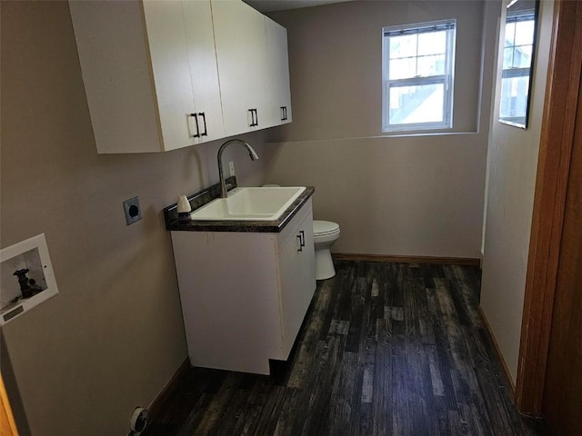 clothes washing area featuring hookup for a washing machine, hookup for an electric dryer, a sink, baseboards, and dark wood finished floors