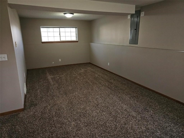 basement with carpet, electric panel, and baseboards