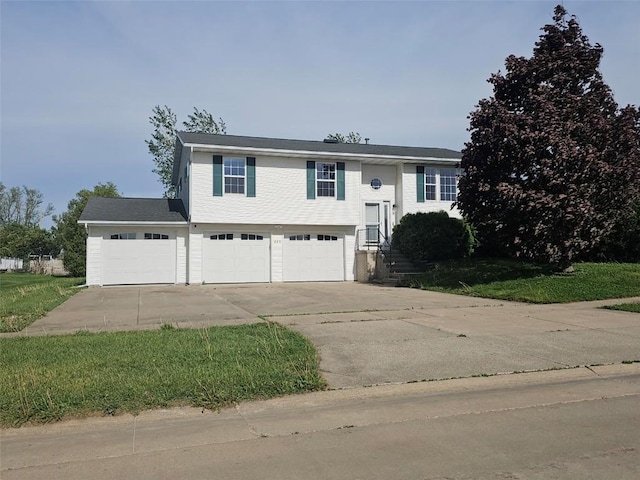 203 Maxwell Dr, Shellsburg, IA 52332 - split foyer home featuring concrete driveway and an attached garage