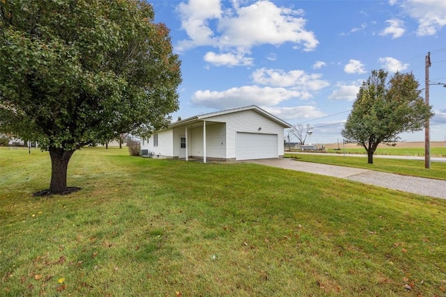 view of home's exterior with a garage, concrete driveway, and a yard