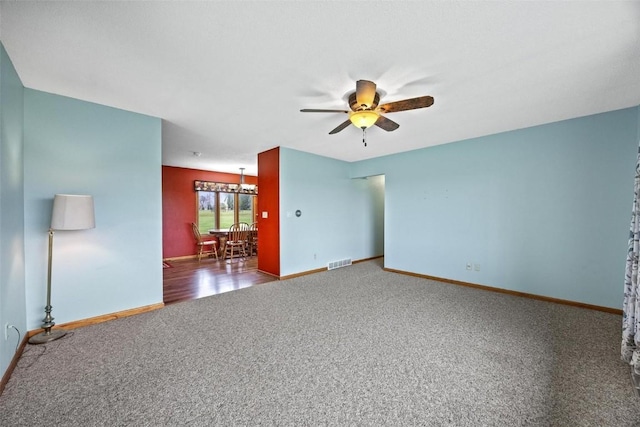 empty room with ceiling fan, carpet, visible vents, and baseboards