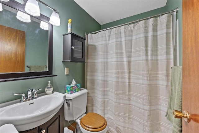 full bathroom featuring vanity, toilet, and a textured ceiling