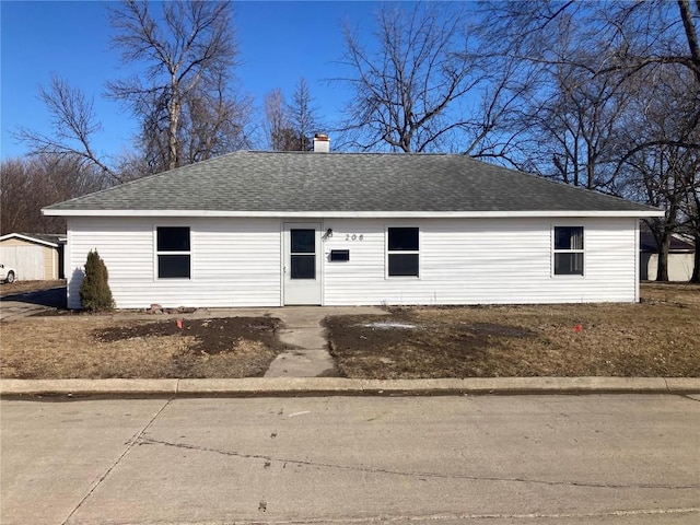 single story home with a chimney and roof with shingles