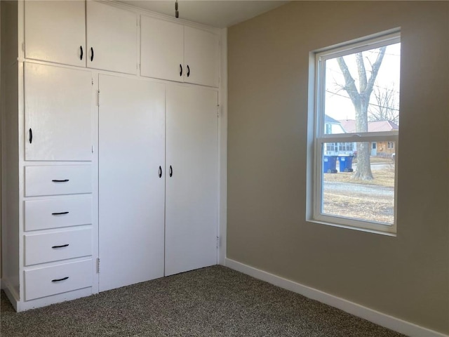 208 G Ave, Vinton, IA 52349 - unfurnished bedroom with carpet, a closet, and baseboards