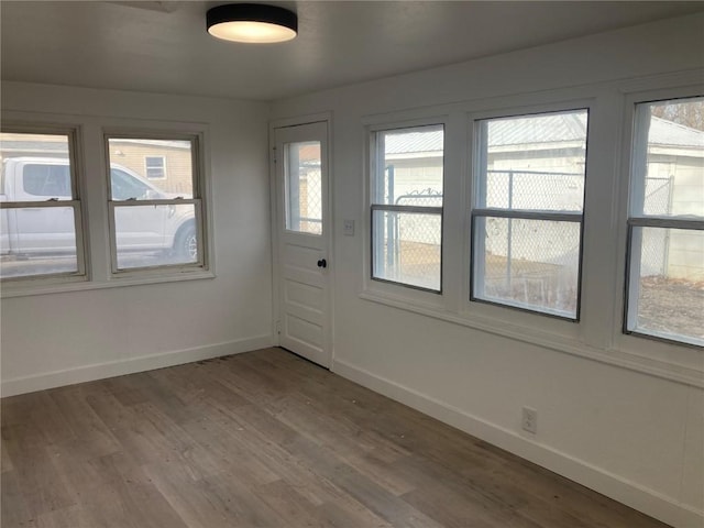 unfurnished sunroom featuring a wealth of natural light