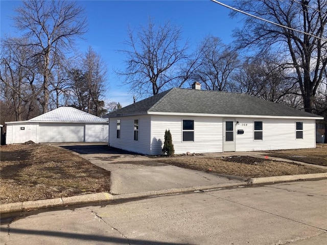 208 G Ave, Vinton, IA 52349 - ranch-style house with a detached garage, an outdoor structure, a chimney, and a shingled roof