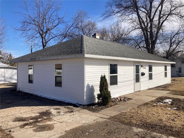 208 G Ave, Vinton, IA 52349 - view of front of property featuring a chimney and roof with shingles