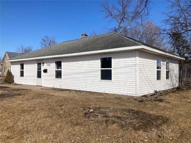 208 G Ave, Vinton, IA 52349 - rear view of property with a chimney and roof with shingles