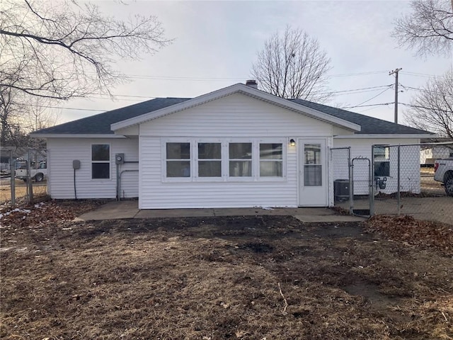 208 G Ave, Vinton, IA 52349 - rear view of property with a gate and roof with shingles