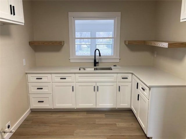 208 G Ave, Vinton, IA 52349 - kitchen featuring open shelves, a sink, white cabinets, and light countertops