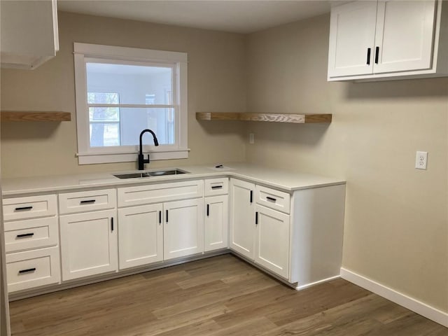 208 G Ave, Vinton, IA 52349 - kitchen featuring a sink, open shelves, and white cabinetry