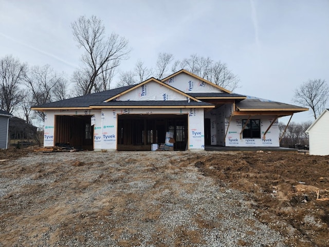 property under construction with an attached garage and dirt driveway