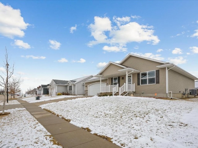 single story home featuring cooling unit and a garage