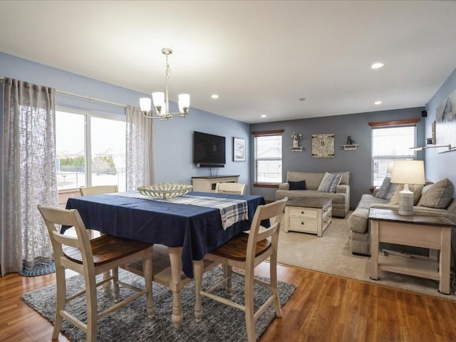 dining room featuring recessed lighting, a notable chandelier, and light wood-style flooring