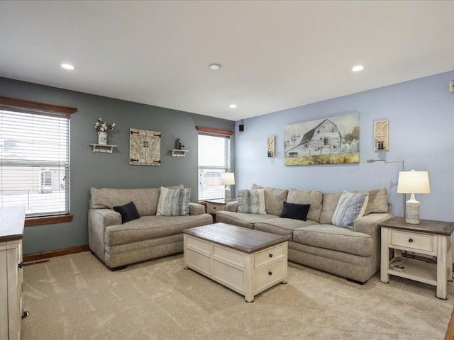 living room with recessed lighting, light colored carpet, and baseboards