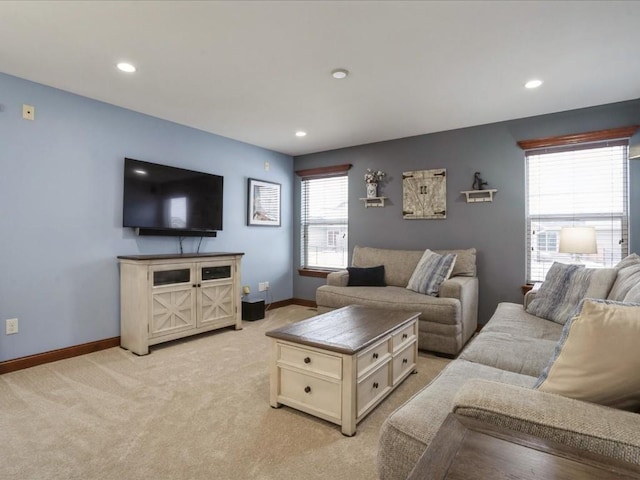 living room with recessed lighting, baseboards, and light colored carpet