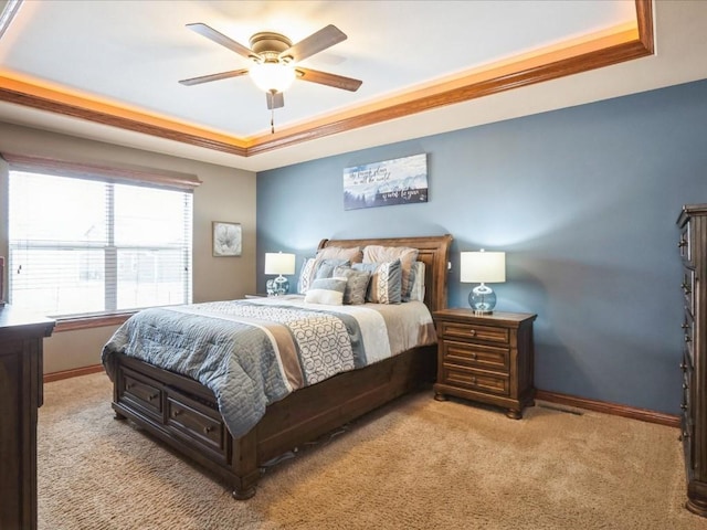 bedroom with a tray ceiling, baseboards, carpet, and ceiling fan