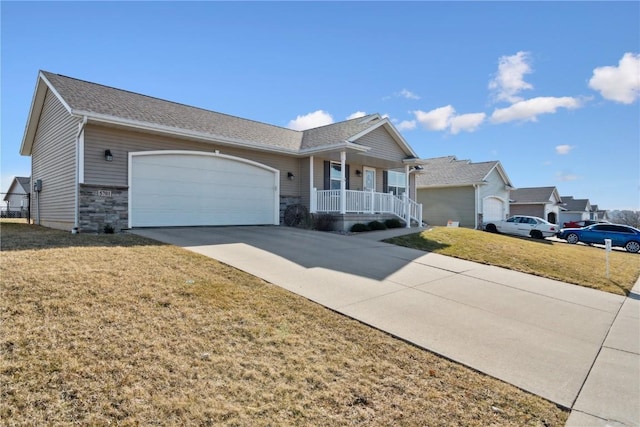 ranch-style house with concrete driveway, a front yard, covered porch, a garage, and stone siding