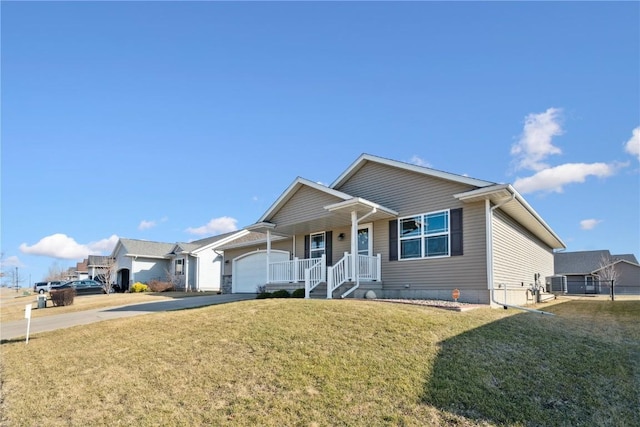 ranch-style house with a front yard, an attached garage, and driveway