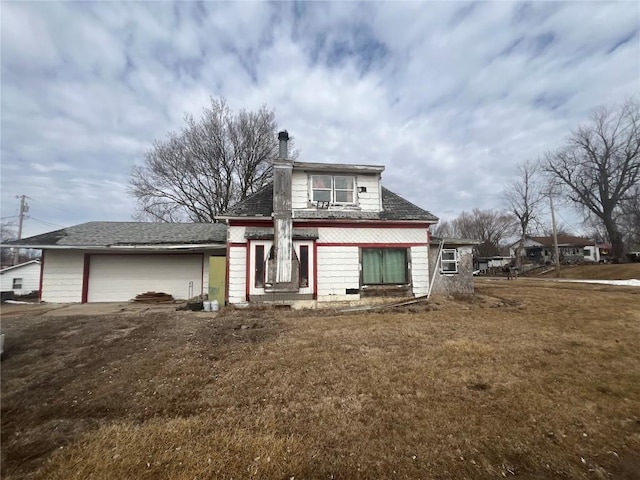 bungalow-style home featuring a front lawn and an attached garage