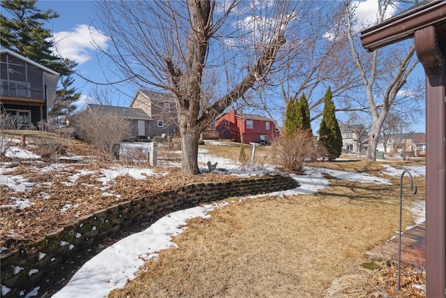 yard covered in snow featuring a residential view