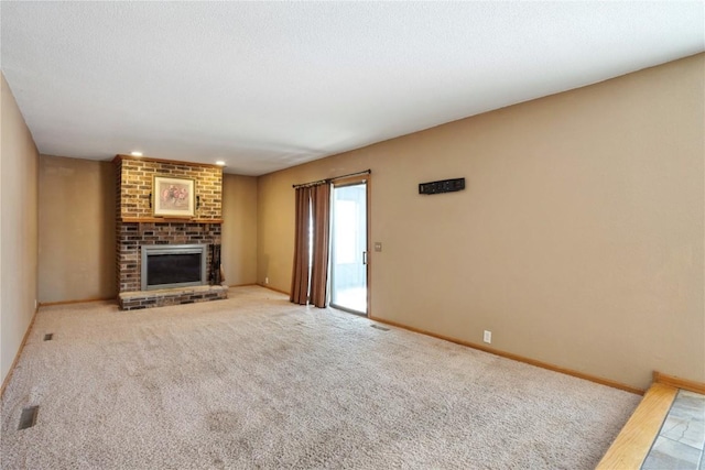 unfurnished living room with carpet floors, a fireplace, and baseboards