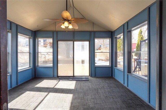 unfurnished sunroom with lofted ceiling, ceiling fan, and a wealth of natural light