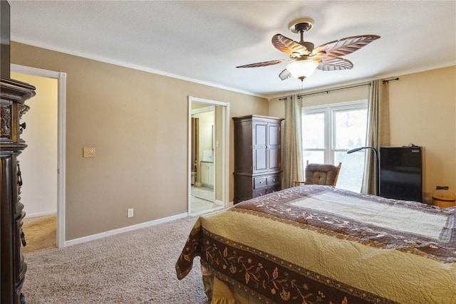 carpeted bedroom with a ceiling fan, crown molding, ensuite bath, and baseboards